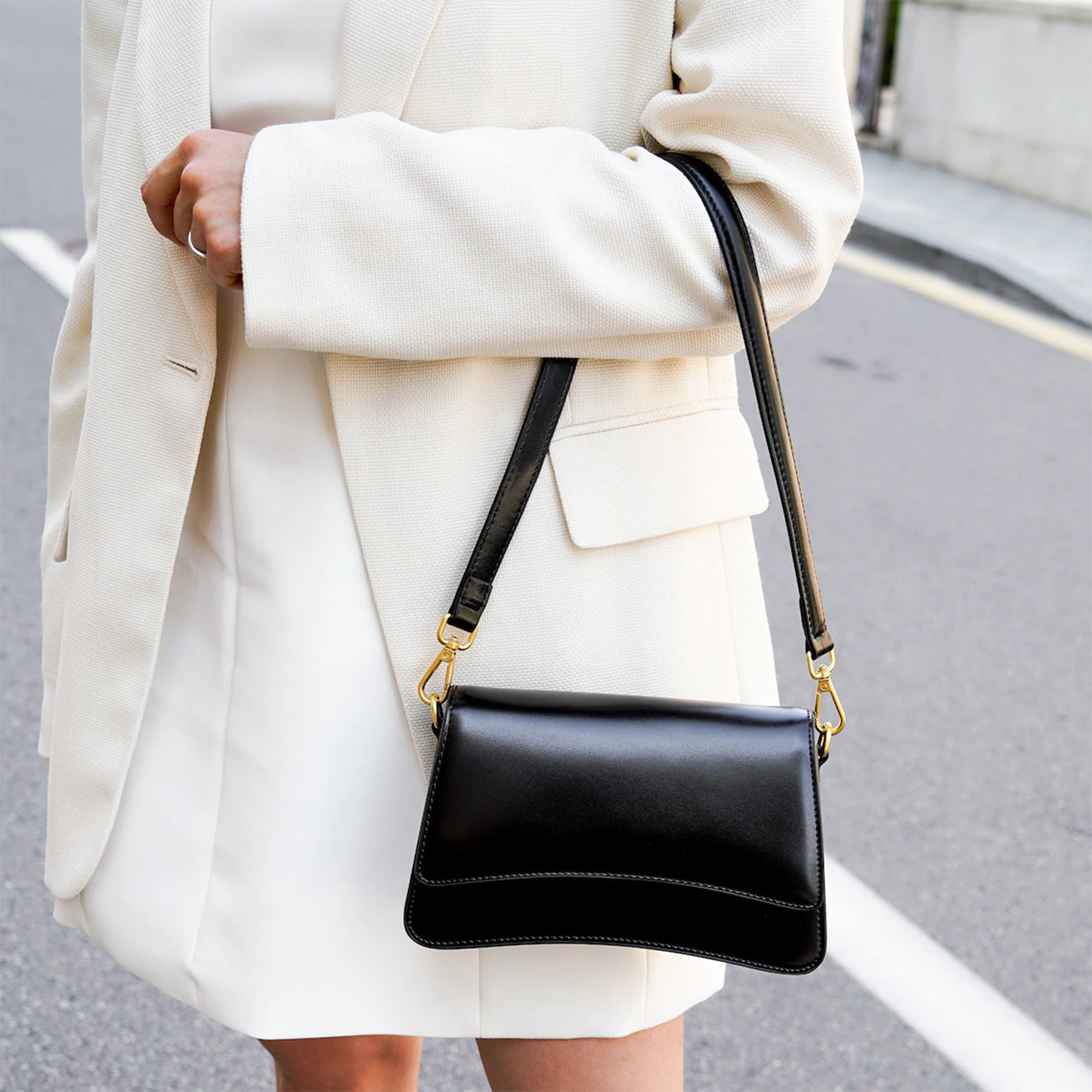 Glossy Black Curved Flap Slim Rectangular Shoulder Pouch With Golden Swivel Clasp Hardware And Single Wide Matching Hanging Strap