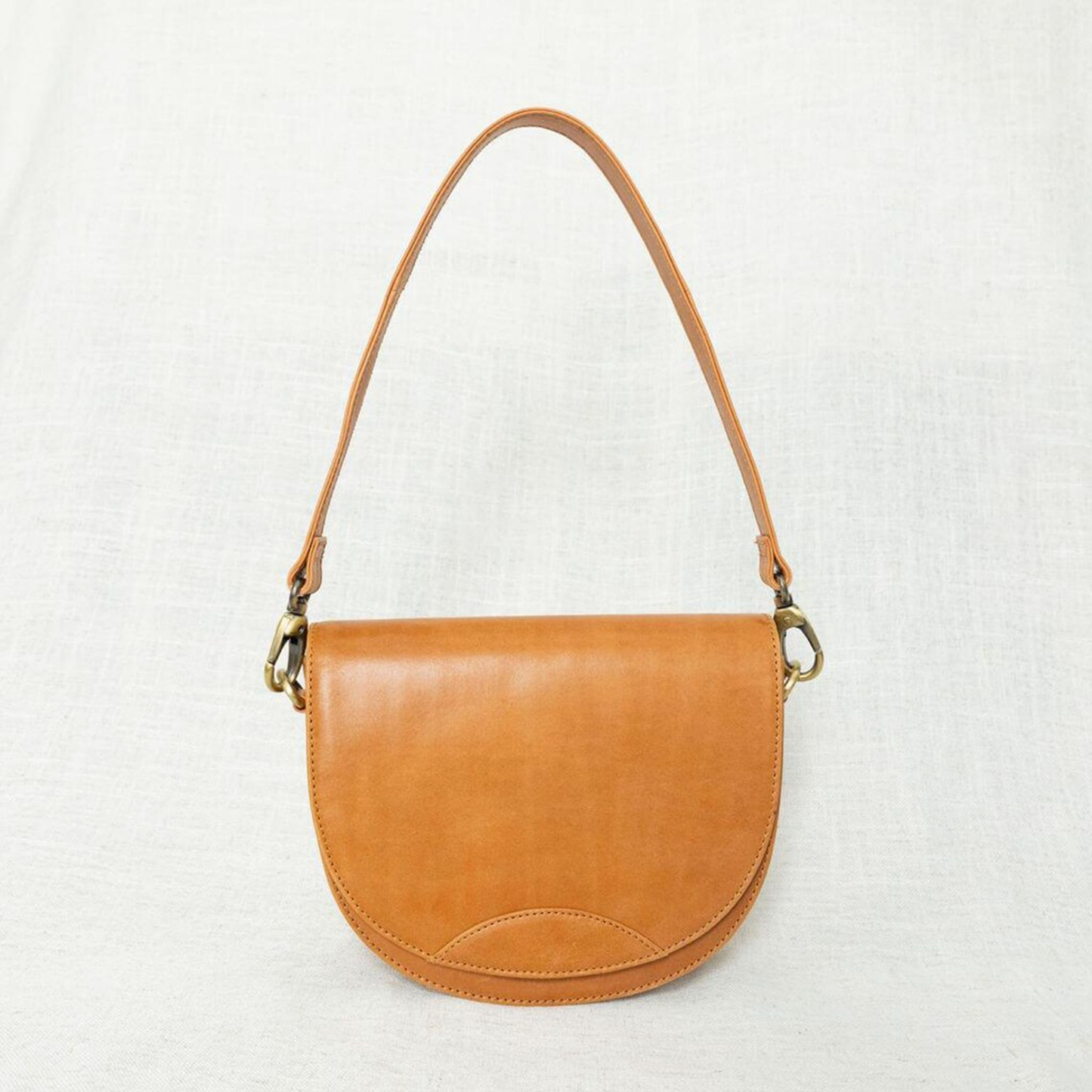 Dual-Tone Layered Half-Moon Saddle Pouch With Golden Swivel Clasp Hardware, Curved Flap Stitch Detailing And Single Slim Shoulder Hanging Strip